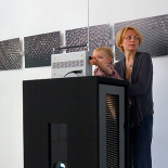 Rūta Mickienė with daughter Meda and the noise visualizations in the background.